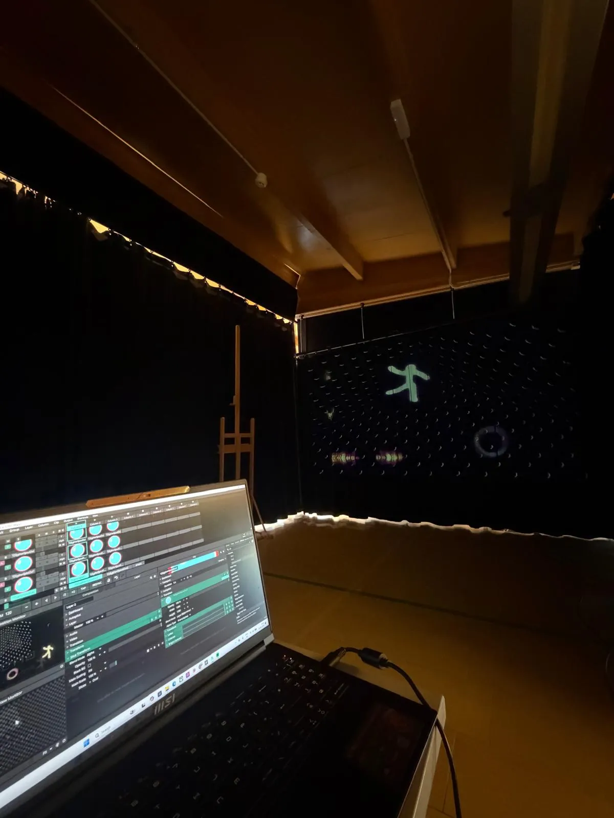 Setup — Resolume running on MSI laptop with four-channel mix, projection on dark curtain