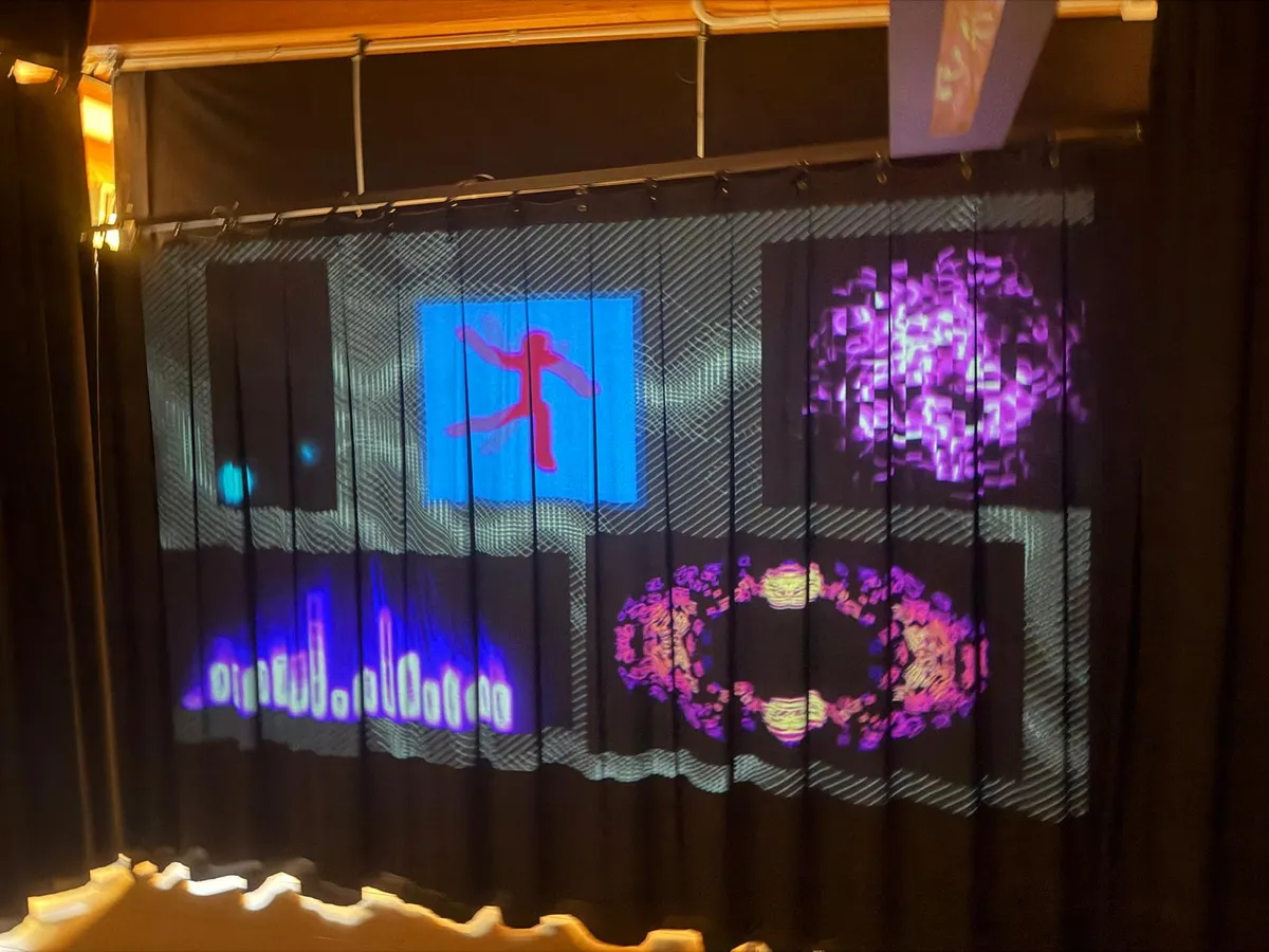 Warm register — blue city light, violet orb, red figure on blue, pink torus